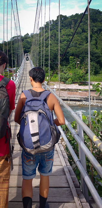 Crossing the river by a bridge on the way to the jungle of Bukit Lawang in Sumatra