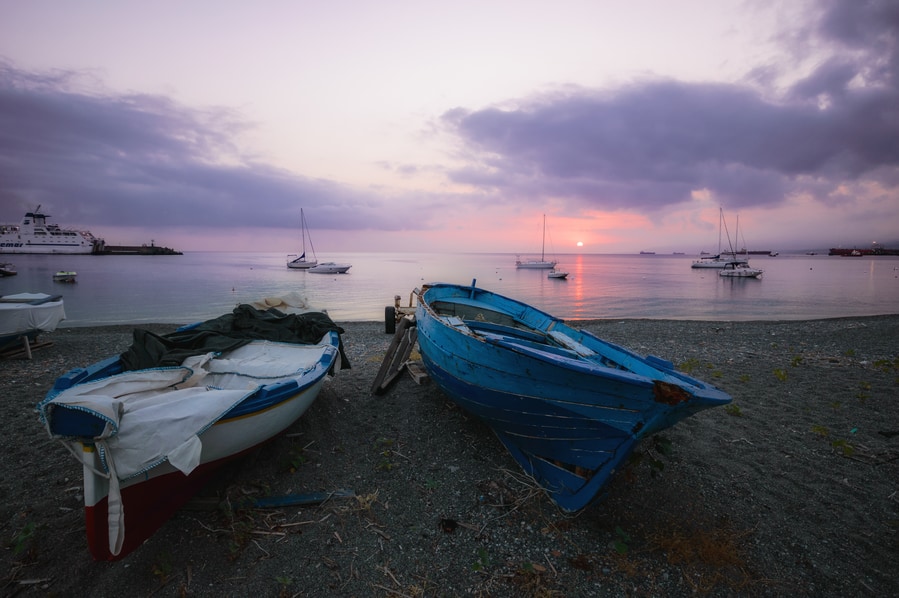 Barcas en la arena de Milazzo al amanecer Sicilia Italia que hacer en stromboli en un dia