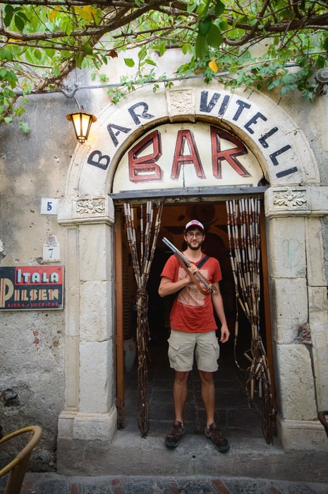 Dani at the door of the Bar Vitelli must see in Savoca Sicily Italy