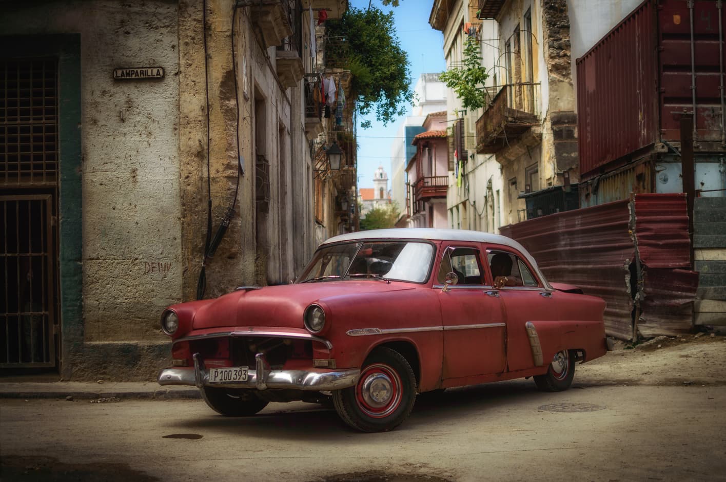 Old red car Lamparilla street old Havana Cuba. Top things to do in Havana. 