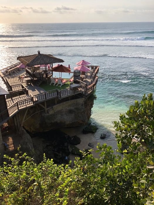 white sand beach of jimbaran with restaurant, one of the best areas to stay in bali