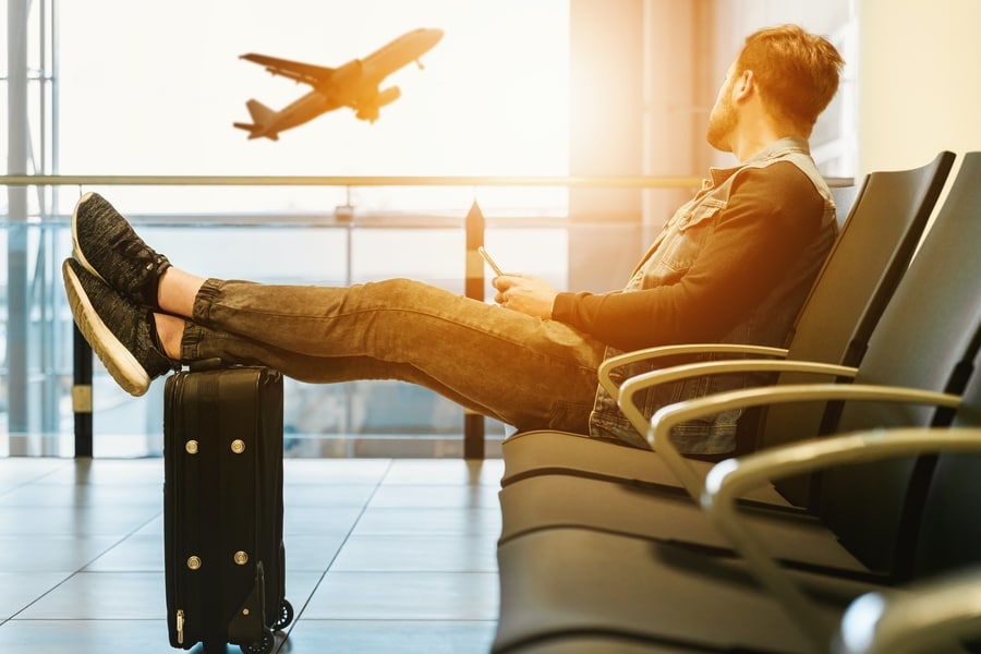 Traveler waiting in airport lounge, heymondo insurance review