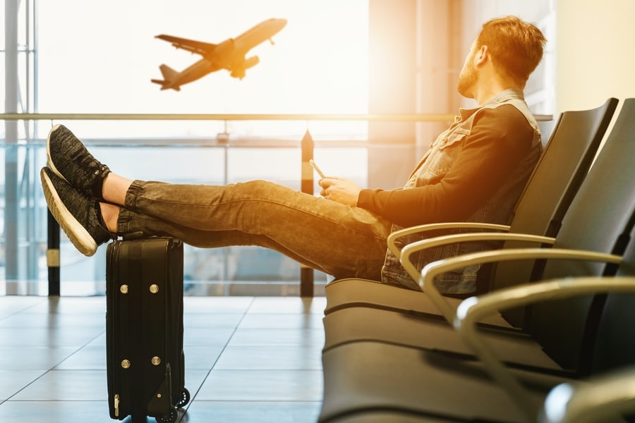 Passenger waiting in airport terminal, planning for a trip