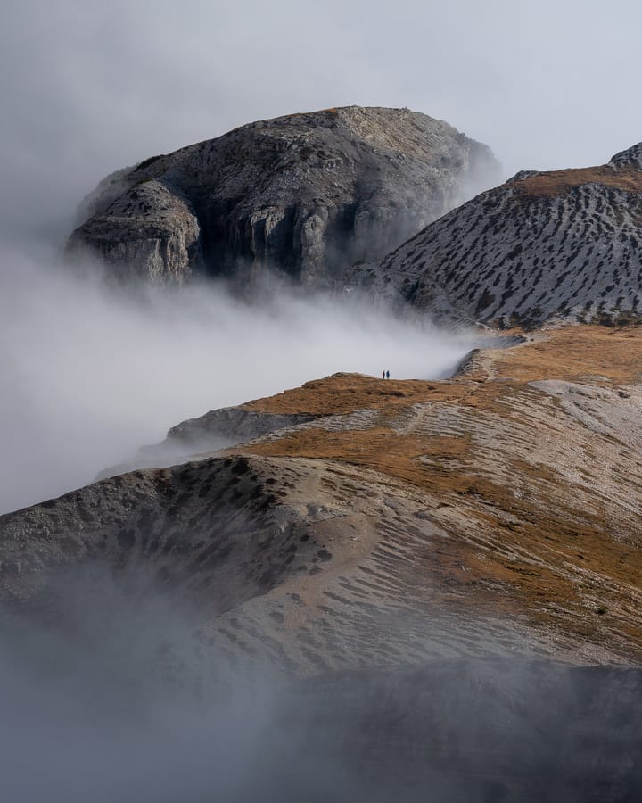 Clouds and moody conditions at mountain pass in Dolomites
