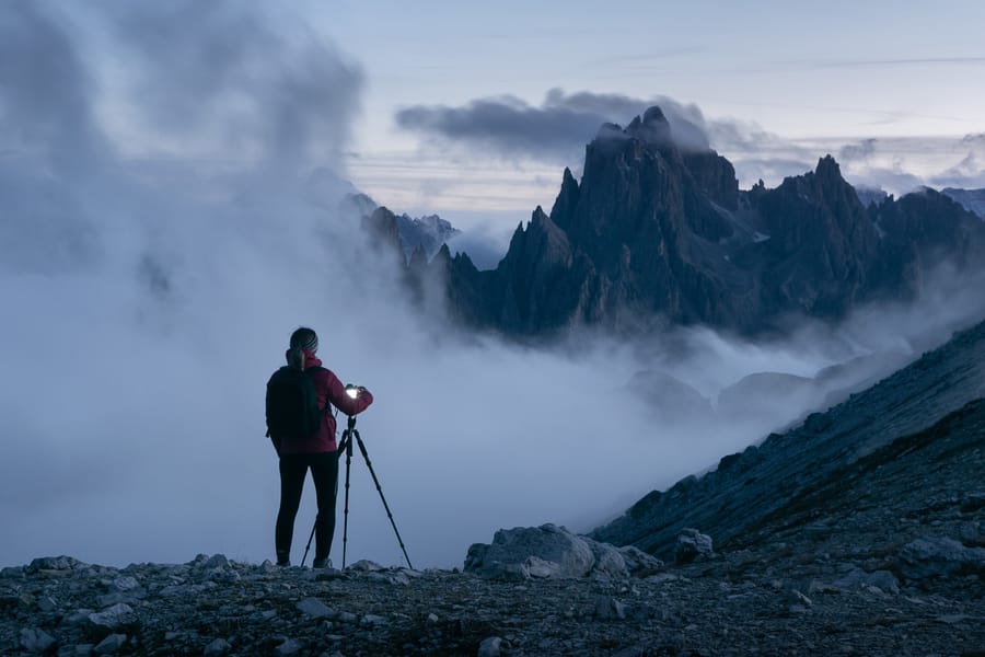 Photographer photographing mountain peaks in the Italian Dolomites