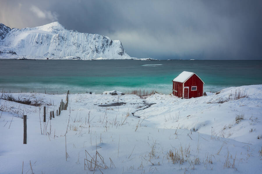 Red house in Ramberg beach during the winter in Lofoten