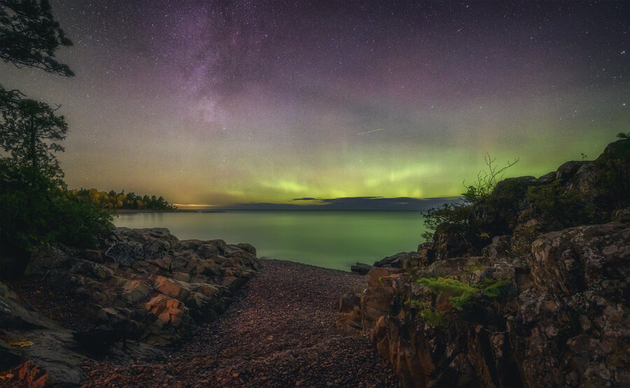 Northern lights photographed over a path leading to a lake in Michigan
