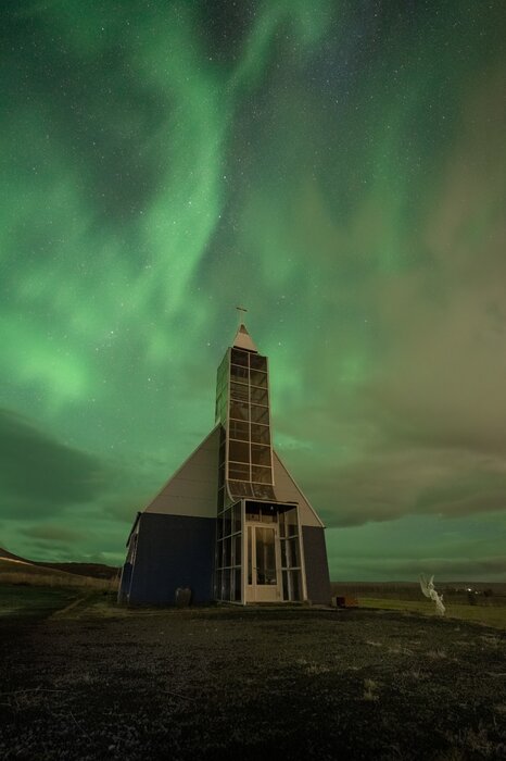Northern lights over Icelandic church during photography tour