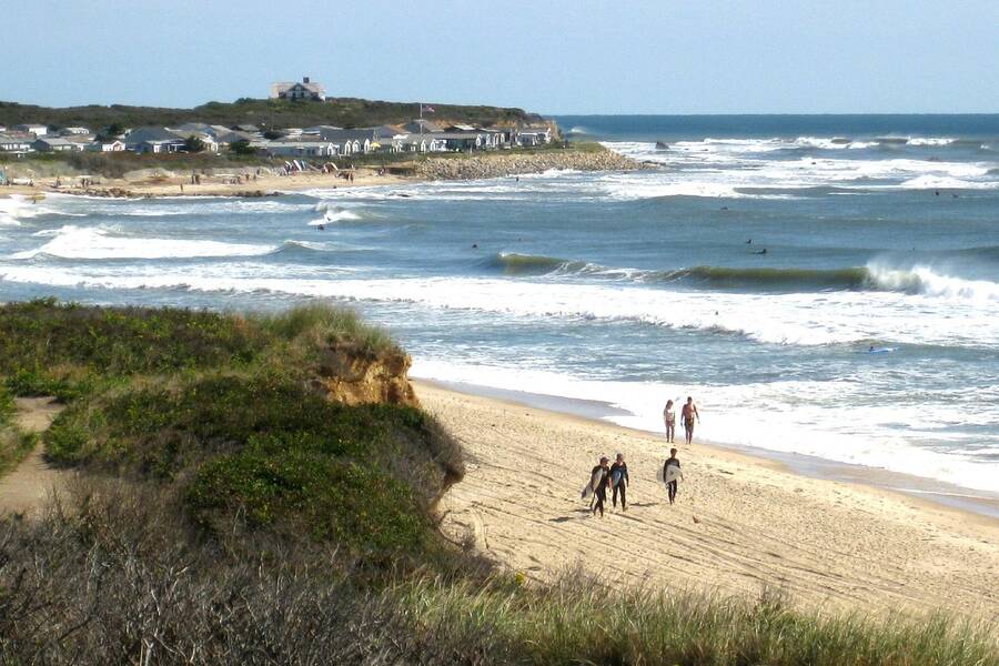 Surfers at Ditch Plains, best beach in the Hamptons