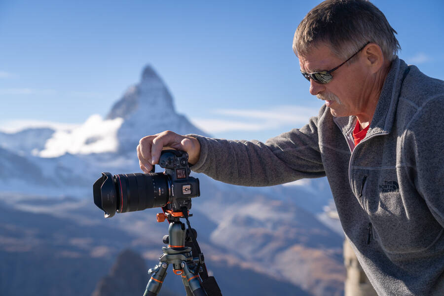 Photographer taking a photo with the Matterhorn behind him