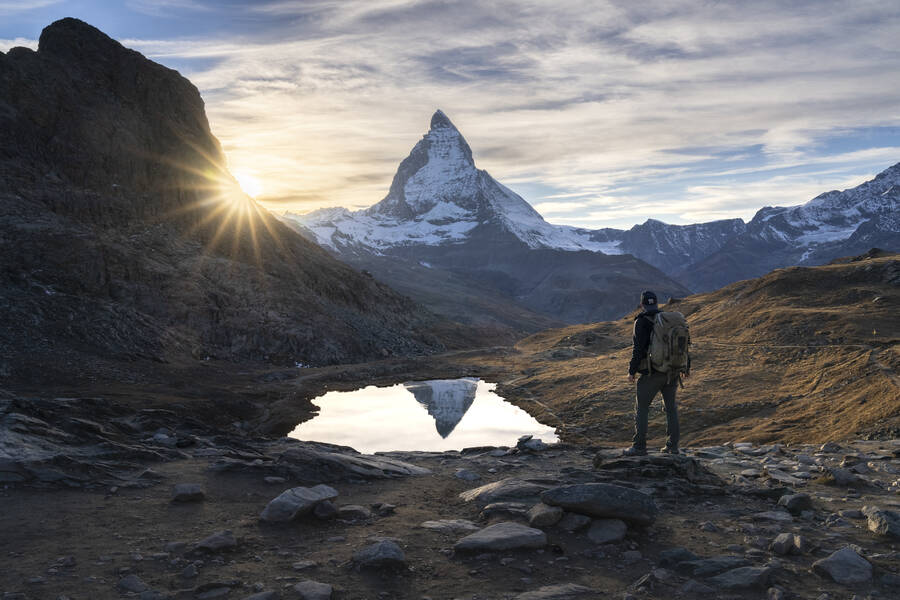 Hiker looking at the Matterhorn during sunset