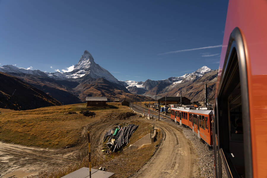 Red train leading to Matterhorn in the Swiss Alps
