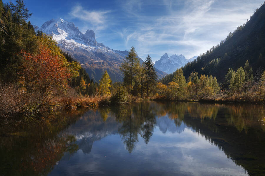 A valley in the French Alps during the fall season with a lake in the foreground