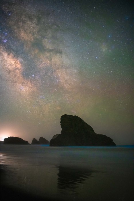 Milky Way covers the sky over a sea stack