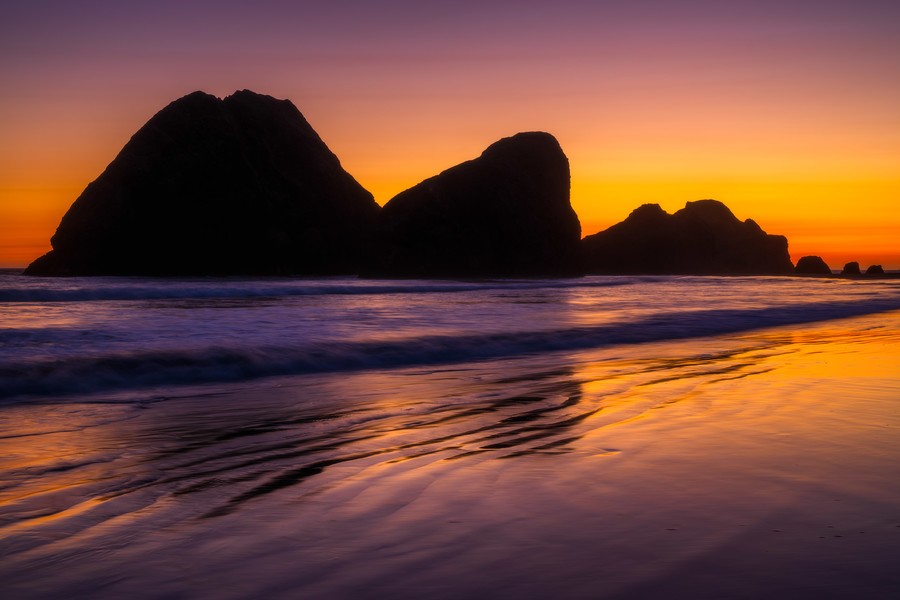 Silhouette of sea stacks during sunset