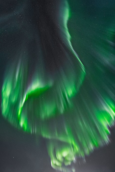 Aurora borealis covering the night sky with a bright green color