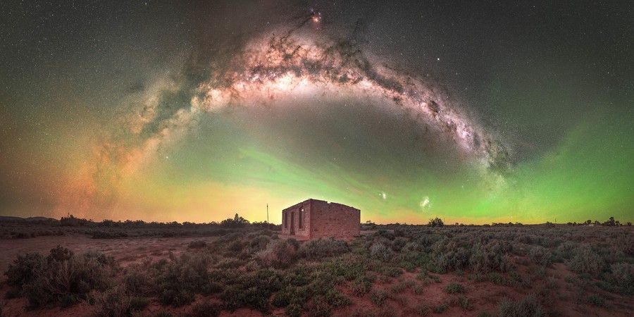 Milky Way arch over an abandoned house in the Australian Outback