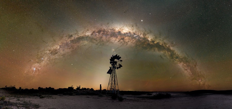 Milky Way arch over windmill silhouette in the Australian Outback