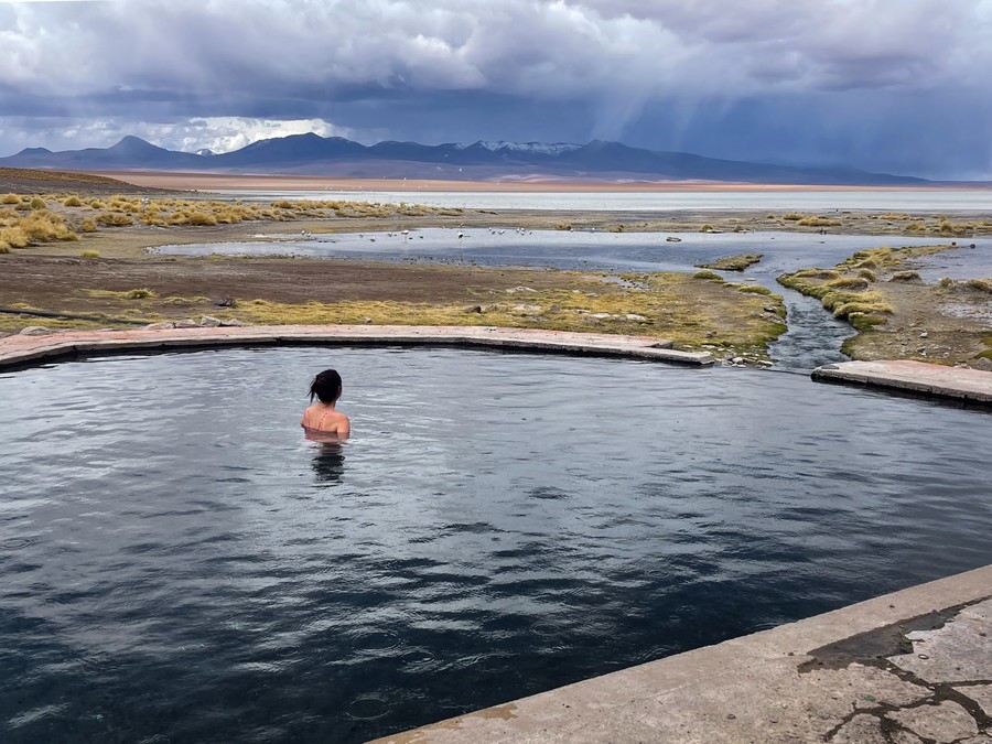 Person relaxing in thermal water pool in the Bolivian Altiplano
