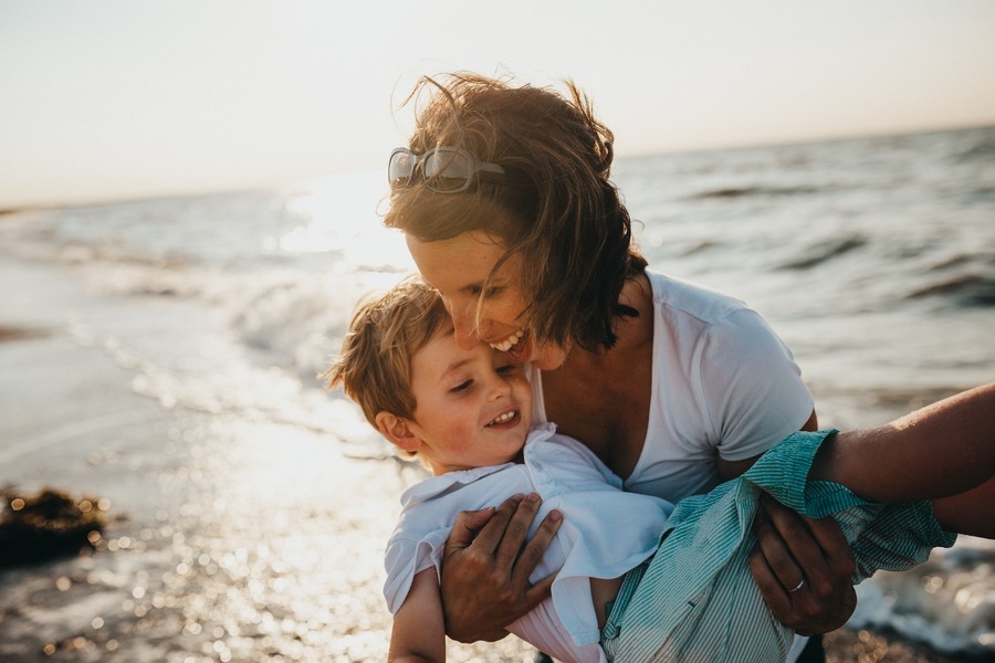 Mother and son at the beach, best family travel insurance
