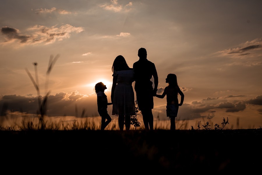 Family at sunset, international travel insurance for families