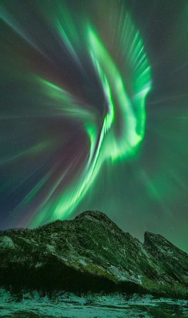 Instense Northern Lights over a mountain