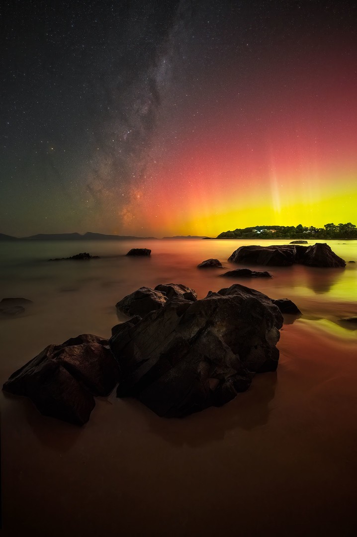 Milky Way core and Northern Lights on the coast