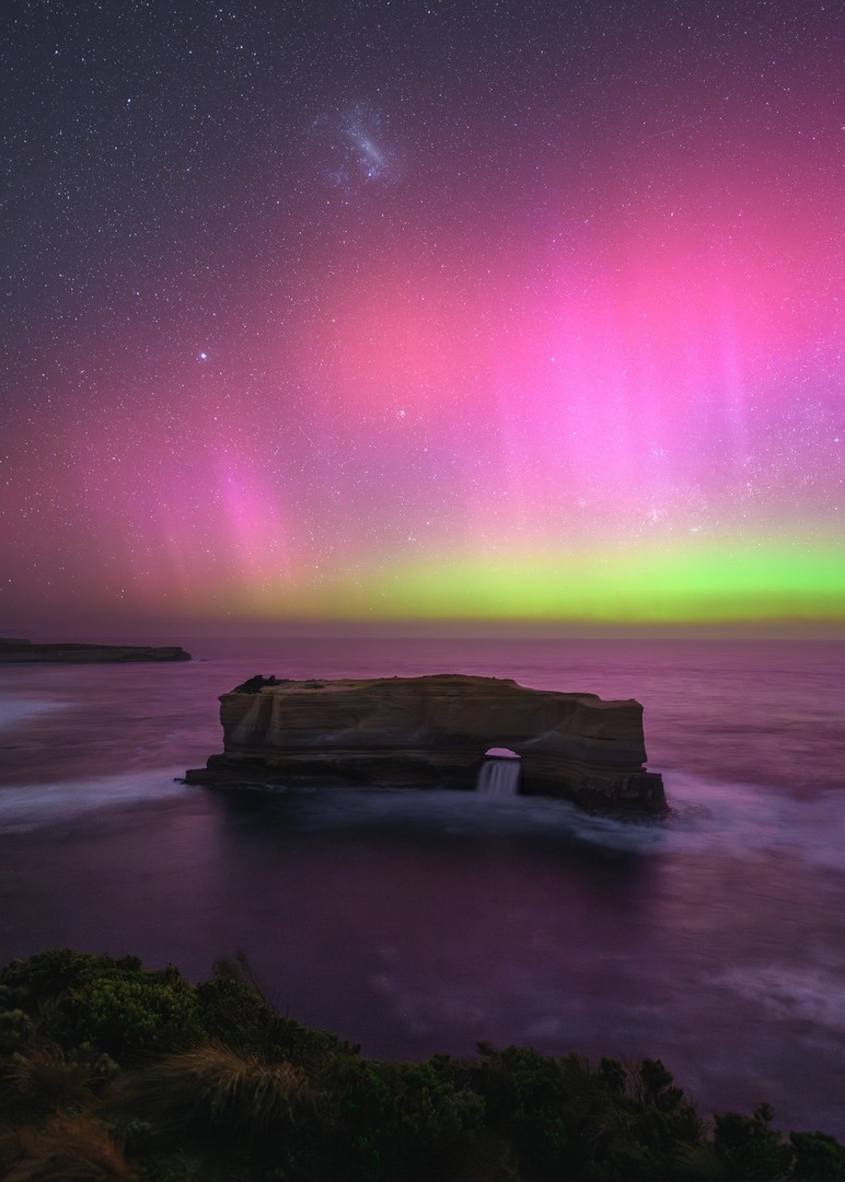 Aurora australis and large magellanic cloud bright in the southern hemisphere night sky