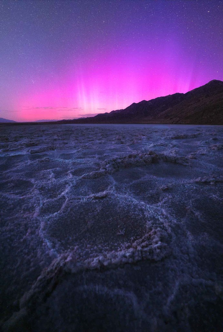 Difuse pink aurora lighting up the night sky in Death Valley