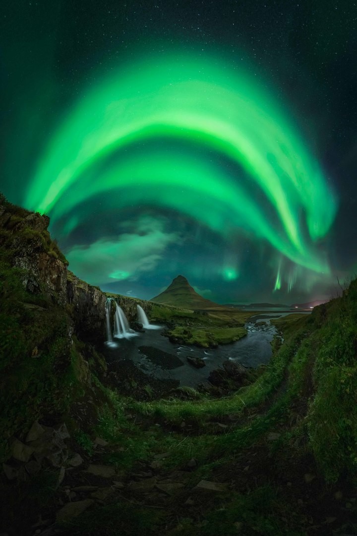 Northern Lights covering the entire sky in a panorama image of Kirkjufell in Iceland