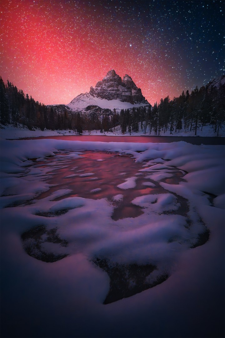 Red bright northern lights in the Dolomites