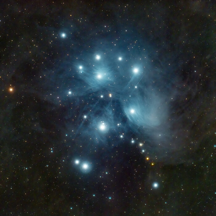 Pleiades star cluster, bright blue stars surrounded by nebulosity deep space