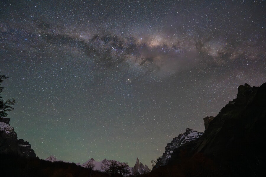 The Milky Way stretches across a starry sky above the rugged mountains of Patagonia