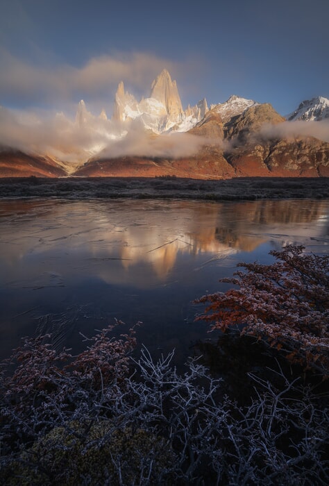 mountain range reflected in clear water