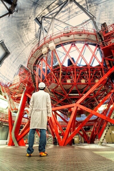Inside a telescope and a man in white