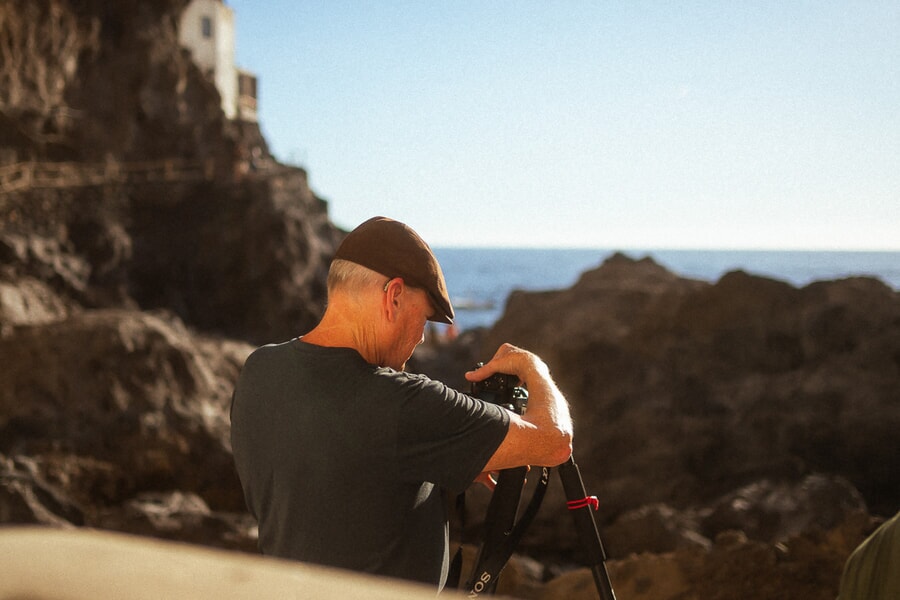 A man with boina taking a picture