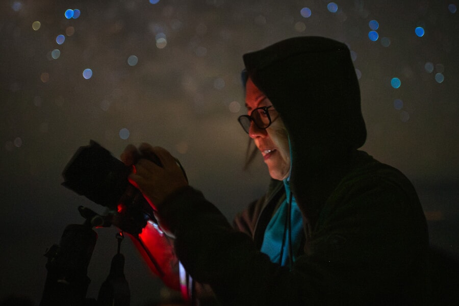 Woman at night taking pictures
